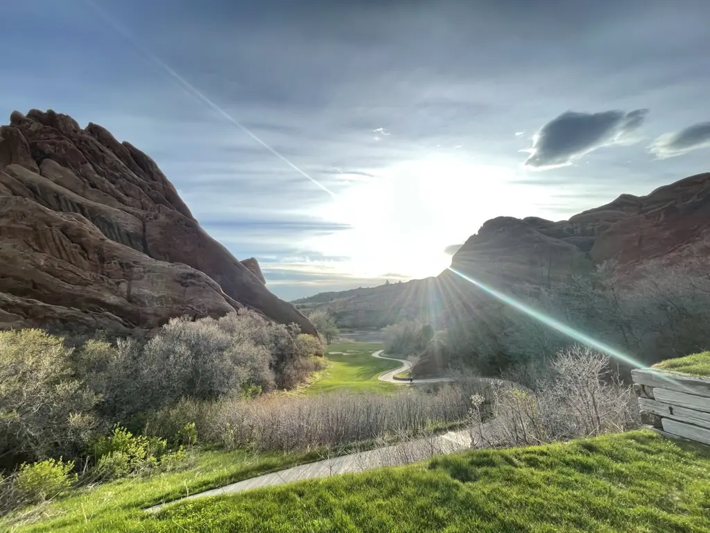 Sunlit canyon landscape with lush greenery.
