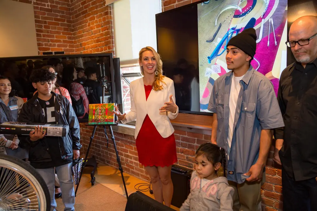People gathered in a room with artwork.