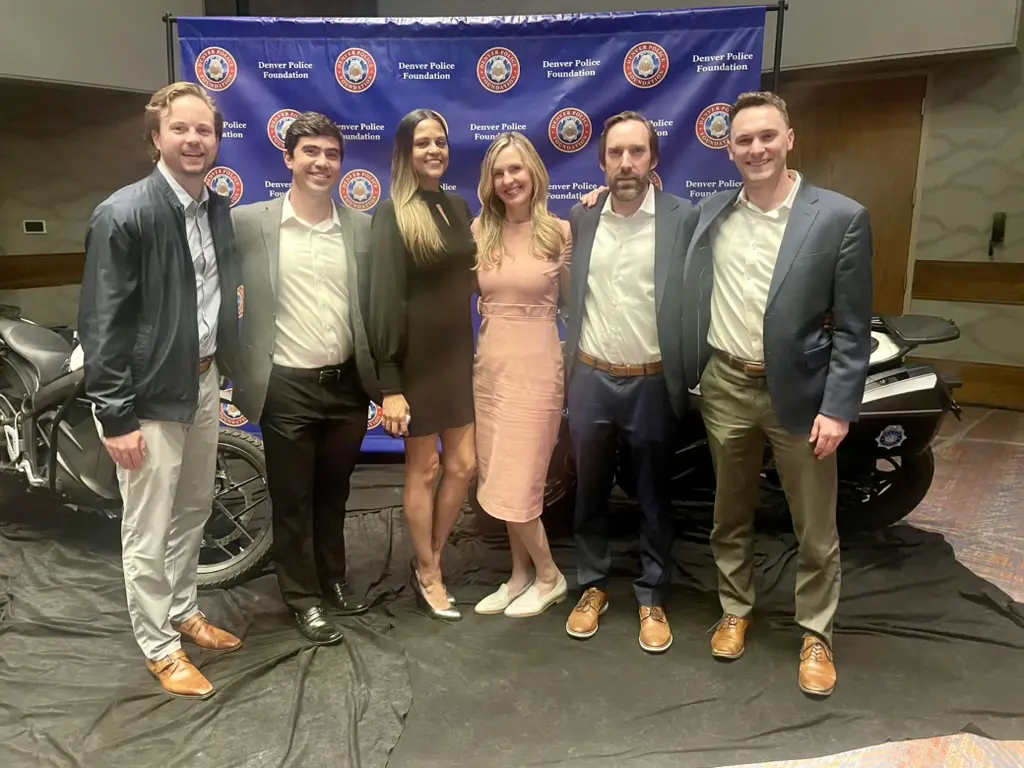 Group posing in front of police foundation backdrop.