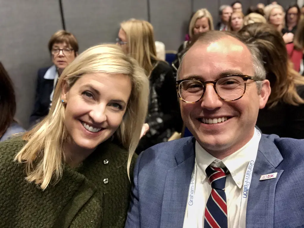 Smiling people at a conference or event.