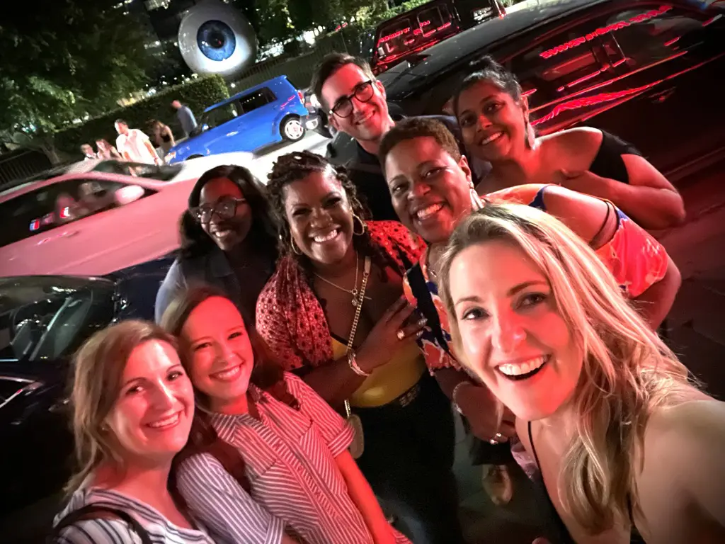 Group of friends smiling on city street.