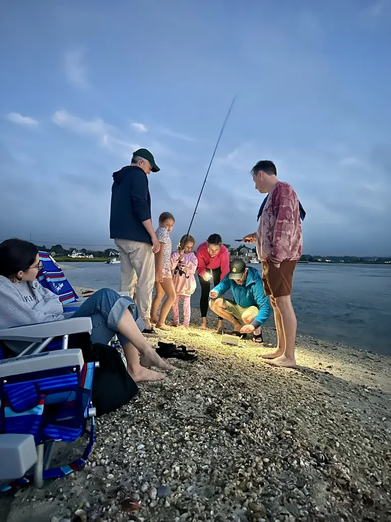 People gathering on beach at night.