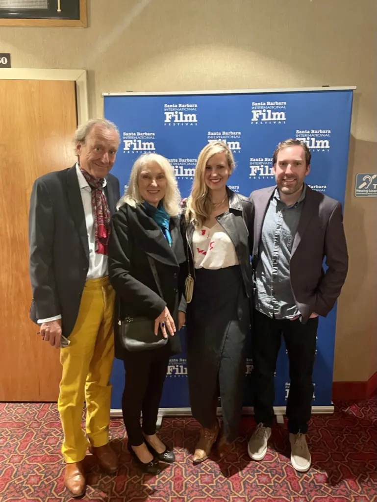Four people posing at film festival event.
