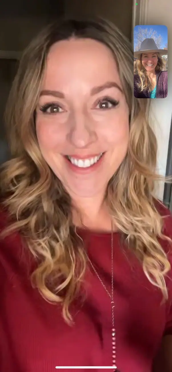 Smiling woman on video call with friend.