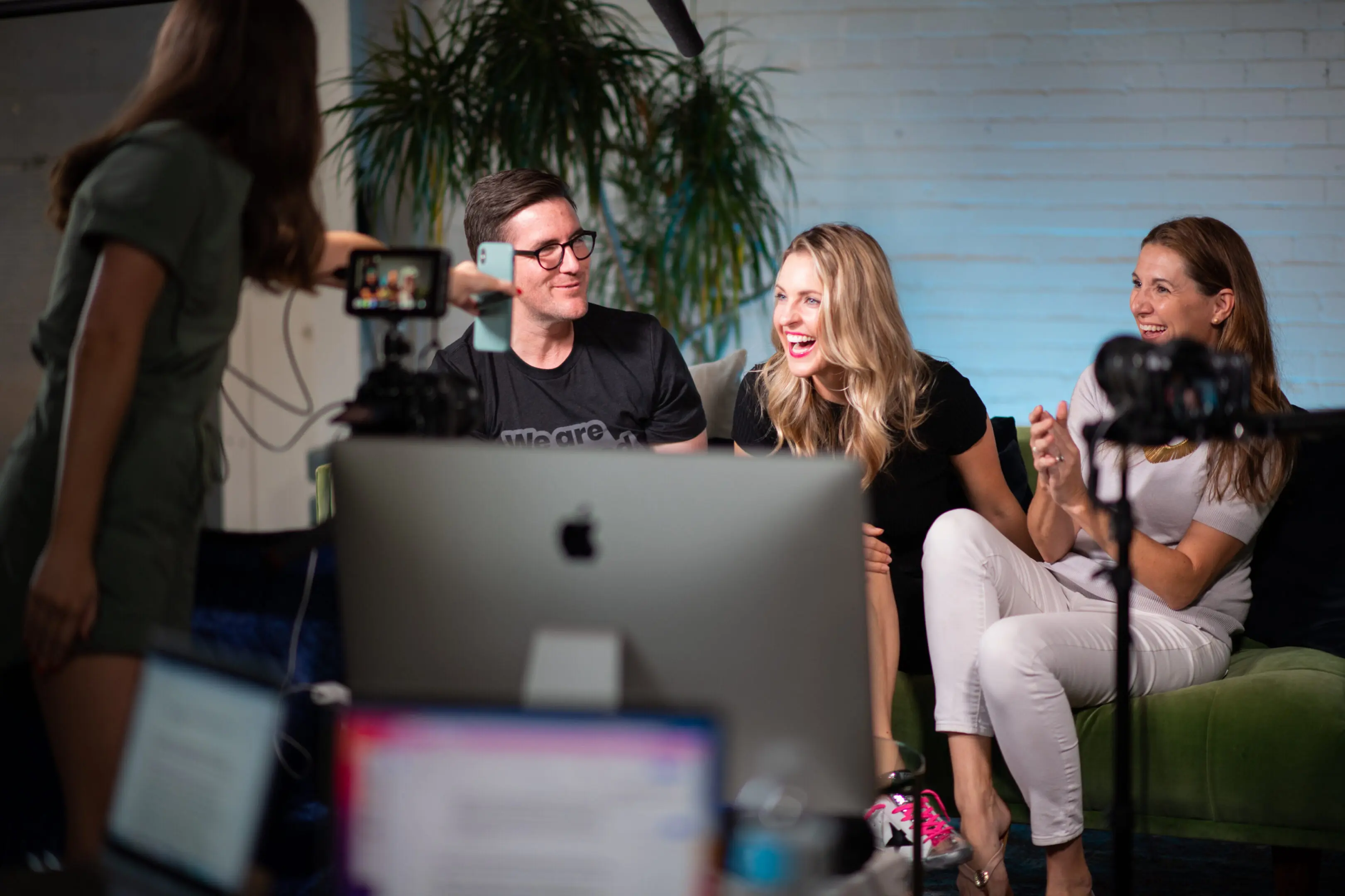 People laughing during a video recording session.
