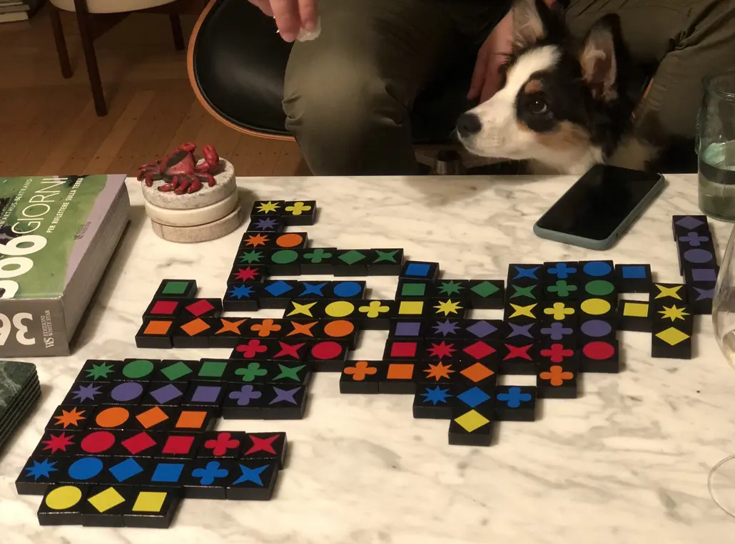 Board game on table with dog watching.