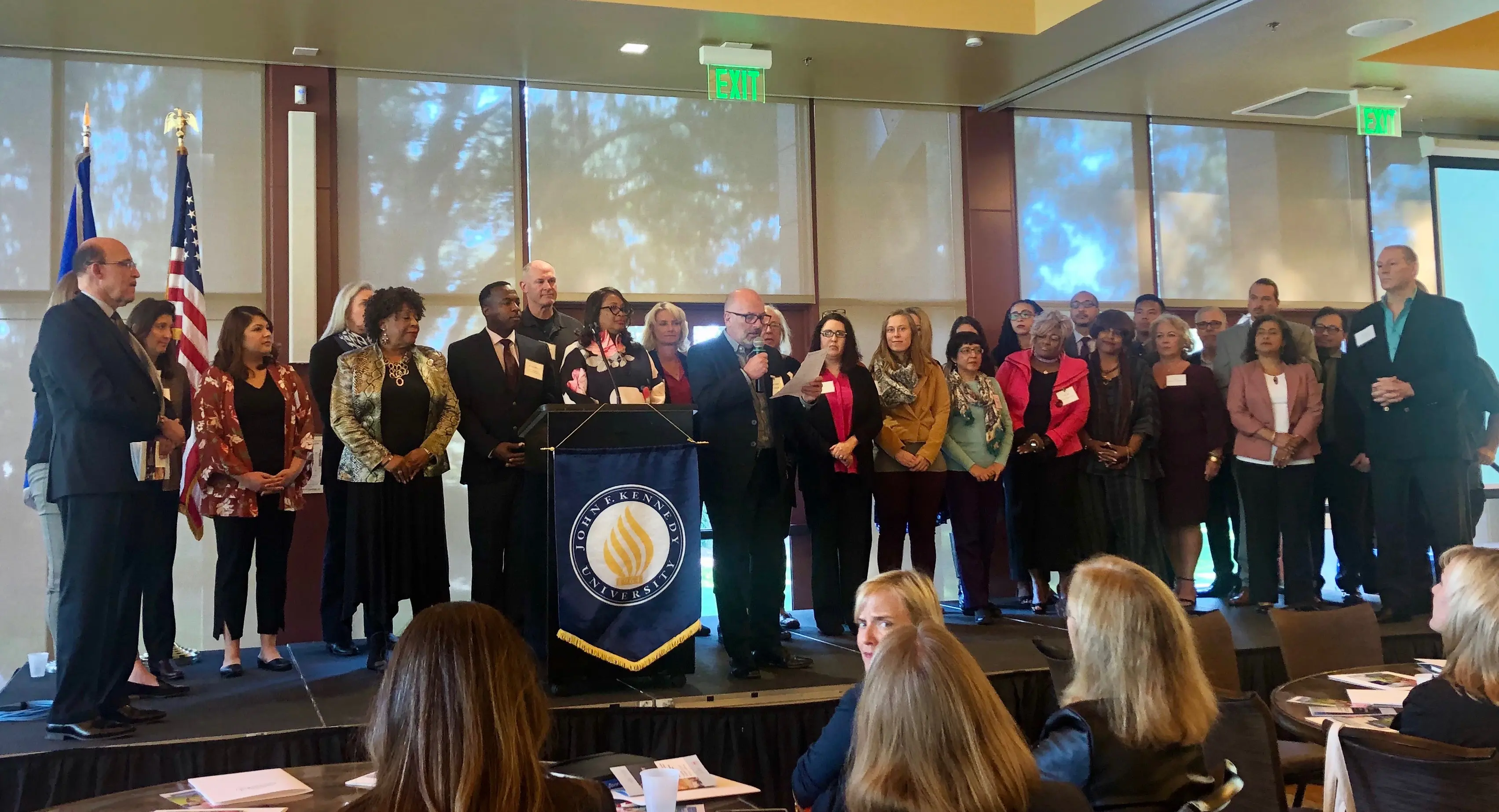 Group of people standing on a stage.