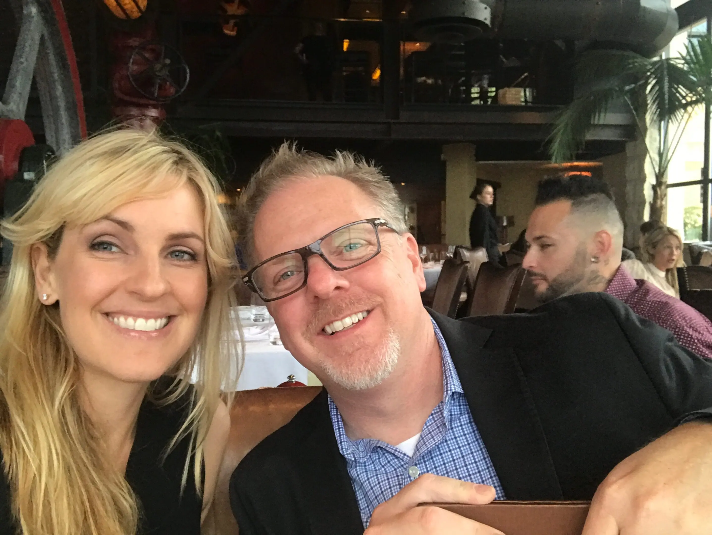 Smiling couple in a restaurant setting.