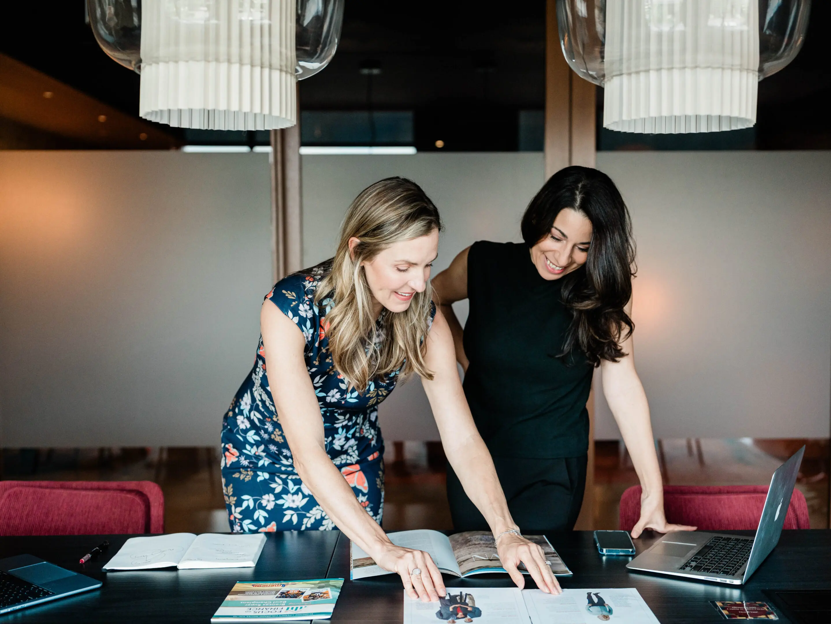Two women collaborating at a table.