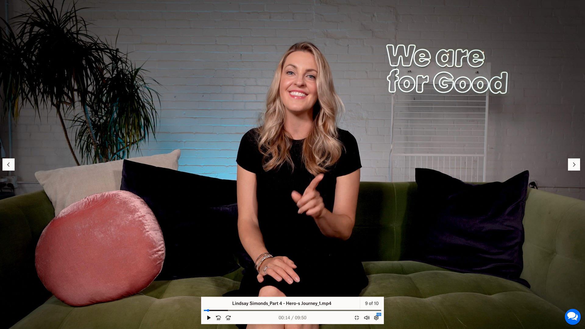 Smiling woman sitting on a green couch.